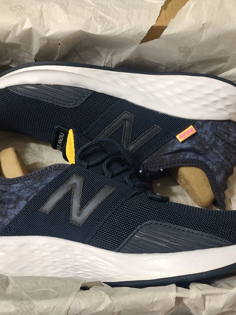 New Balance Roav Navy and White Women's Athletic Sneakers with Yellow Tongue Tab
